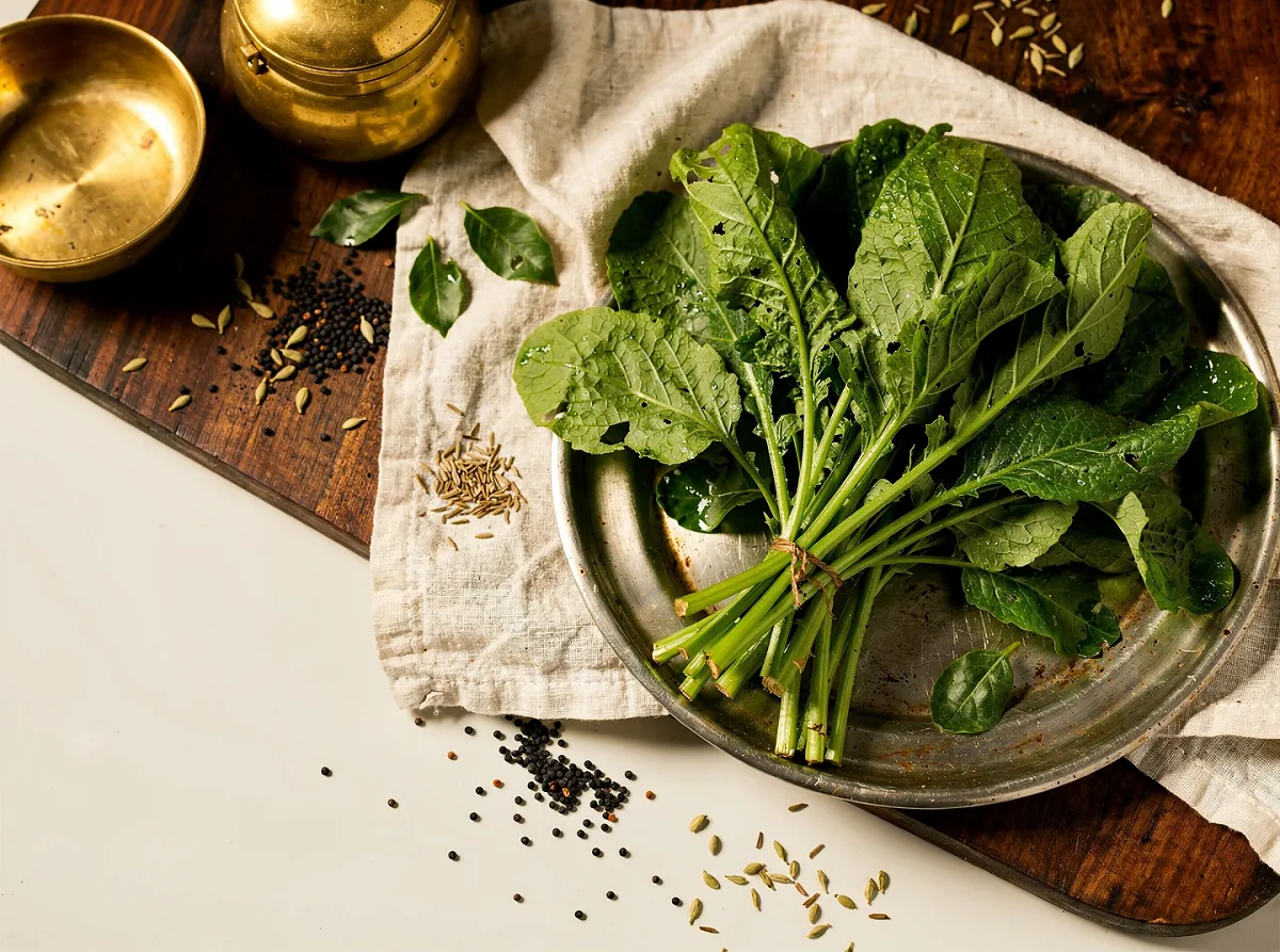 Fresh dark green radish leaves with tender stems, ready for cooking